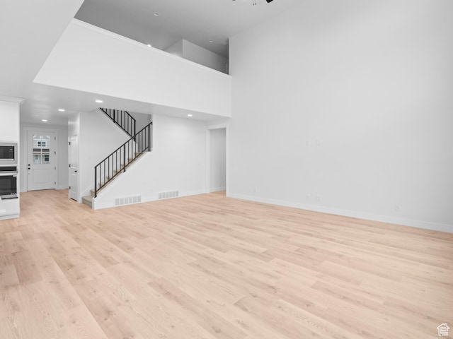 1171 W 800 S Unit 38, Spanish Fork, UT 84660 - unfurnished living room with stairway, visible vents, and light wood-type flooring