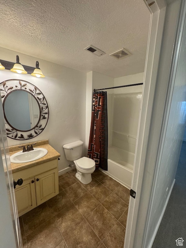 full bath featuring toilet, a textured ceiling, vanity, and visible vents