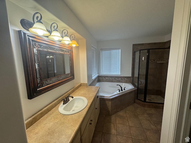 full bath with a stall shower, tile patterned flooring, a garden tub, and vanity