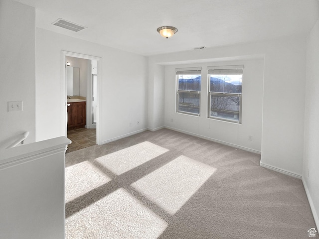 307 W Park View Ln, Spanish Fork, UT 84660 - unfurnished bedroom with baseboards, connected bathroom, visible vents, and light colored carpet