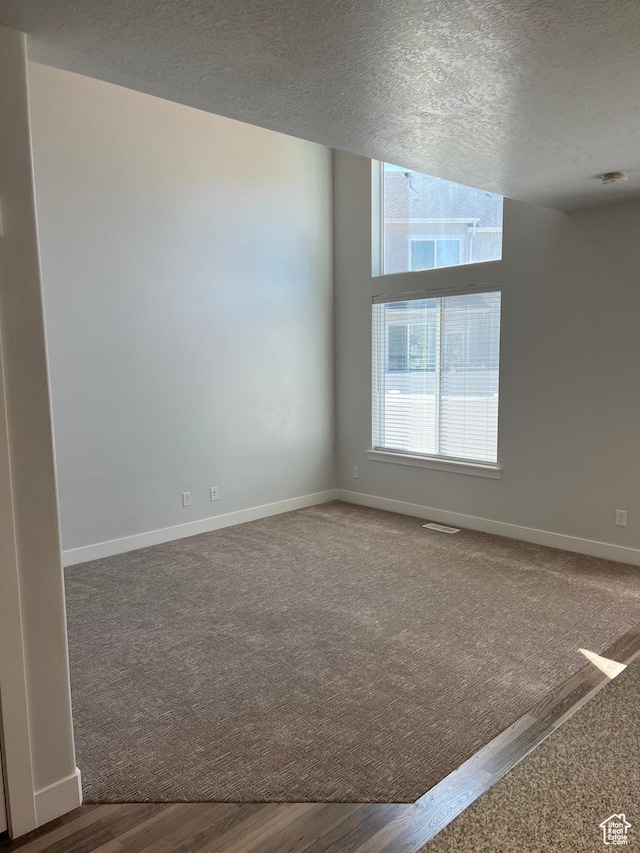 16368 S Coupler Ln, Bluffdale, UT 84065 - empty room featuring visible vents, a textured ceiling, baseboards, and wood finished floors