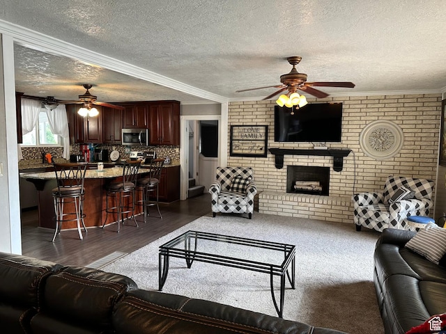 371 S Willard Peak Rd S, Mantua, UT 84324 - living area with ornamental molding, wood finished floors, brick wall, a brick fireplace, and ceiling fan