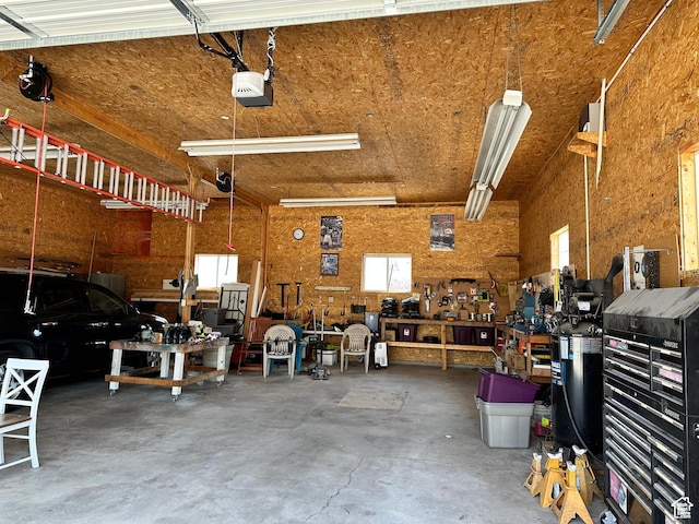 371 S Willard Peak Rd S, Mantua, UT 84324 - garage with a workshop area and a garage door opener