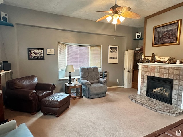 371 S Willard Peak Rd S, Mantua, UT 84324 - living area featuring a ceiling fan, baseboards, a textured ceiling, a glass covered fireplace, and carpet flooring