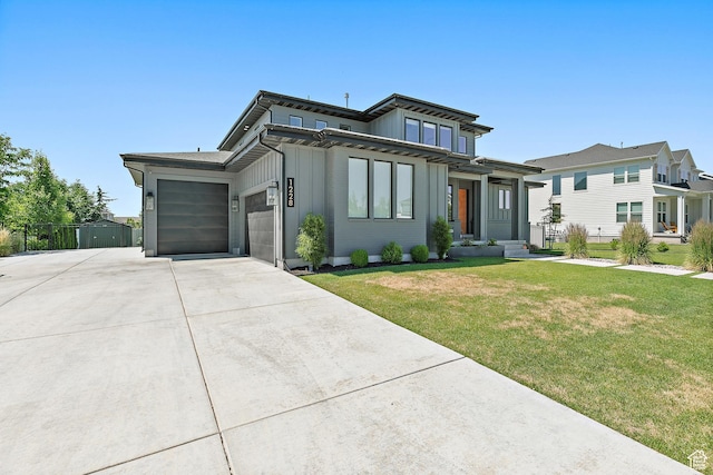 1228 E 1030 N, American Fork, UT 84003 - view of front of home featuring driveway, a garage, a front yard, and board and batten siding