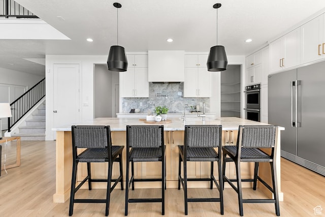 1228 E 1030 N, American Fork, UT 84003 - kitchen featuring stainless steel appliances, light wood-style flooring, decorative backsplash, white cabinets, and recessed lighting