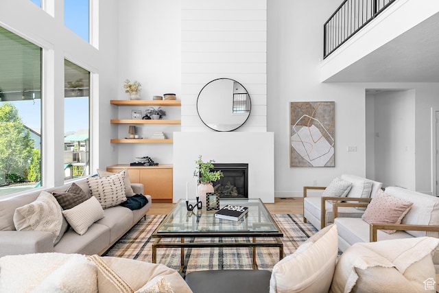 1228 E 1030 N, American Fork, UT 84003 - living room with healthy amount of natural light, a high ceiling, light wood-style floors, and a large fireplace