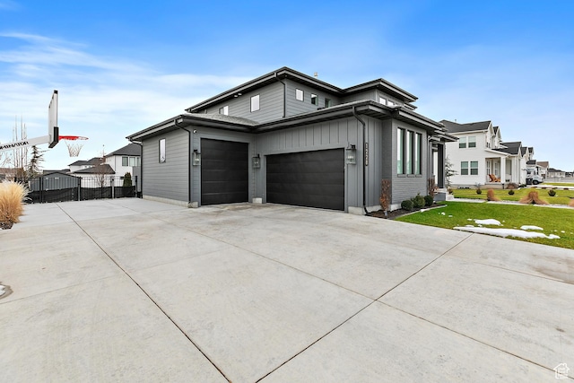 1228 E 1030 N, American Fork, UT 84003 - view of front of home featuring concrete driveway, board and batten siding, a front yard, and fence