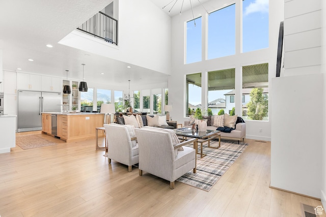 1228 E 1030 N, American Fork, UT 84003 - living area with light wood-style flooring, a high ceiling, recessed lighting, and a chandelier