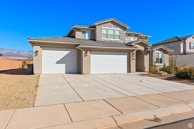 4712 W 2820 S, Hurricane, UT 84737 - traditional home with stucco siding, a tile roof, concrete driveway, stone siding, and fence