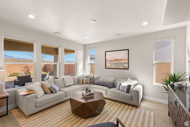 4712 W 2820 S, Hurricane, UT 84737 - living room featuring healthy amount of natural light, baseboards, light wood-type flooring, recessed lighting, and a textured ceiling