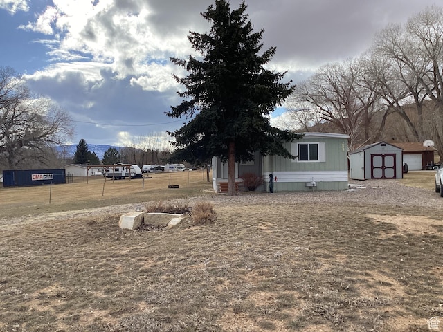 255 N 1st St E, Manila, UT 84046 - view of yard featuring fence, a shed, and an outbuilding