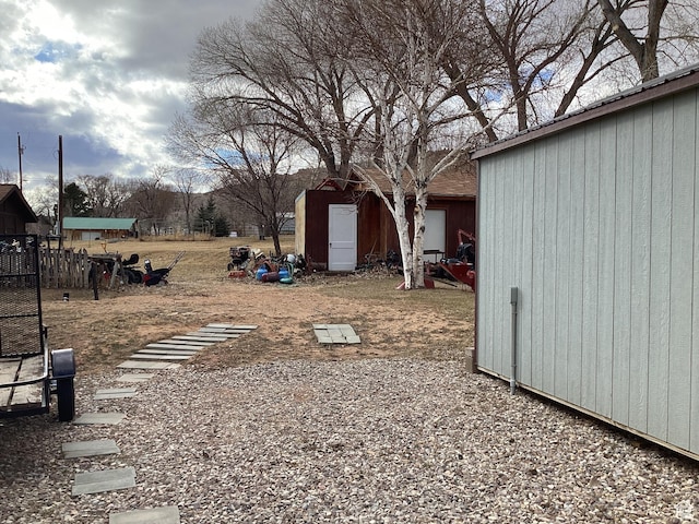 255 N 1st St E, Manila, UT 84046 - view of yard with fence, a storage unit, and an outbuilding