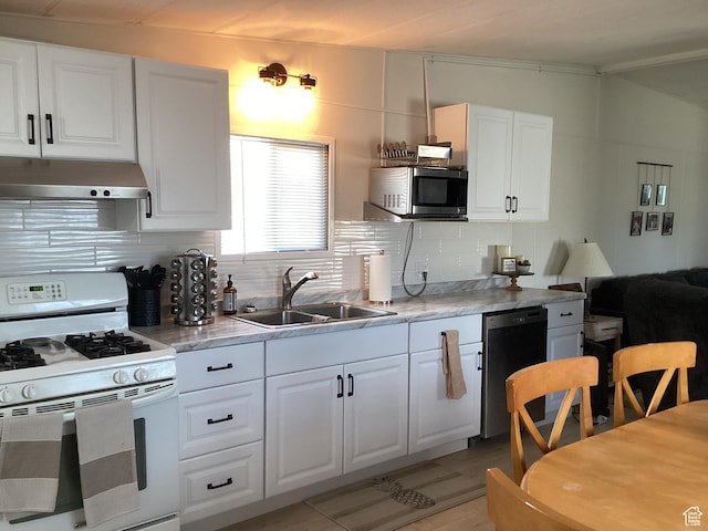 255 N 1st St E, Manila, UT 84046 - kitchen featuring white gas range oven, stainless steel microwave, a sink, under cabinet range hood, and dishwasher