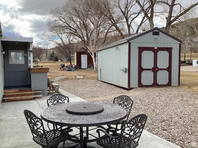255 N 1st St E, Manila, UT 84046 - view of patio featuring a storage unit and an outdoor structure