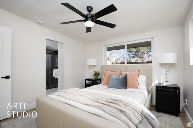 bedroom with a ceiling fan, a textured ceiling, and baseboards