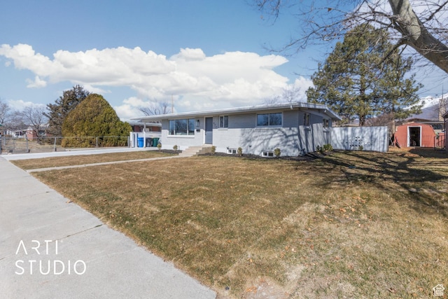 single story home with entry steps, brick siding, a front yard, and fence