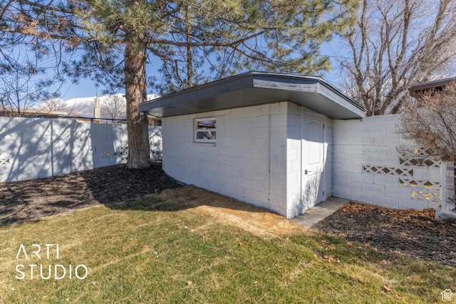view of outbuilding featuring fence