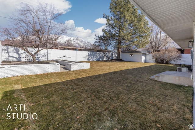 view of yard featuring an outbuilding and a fenced backyard