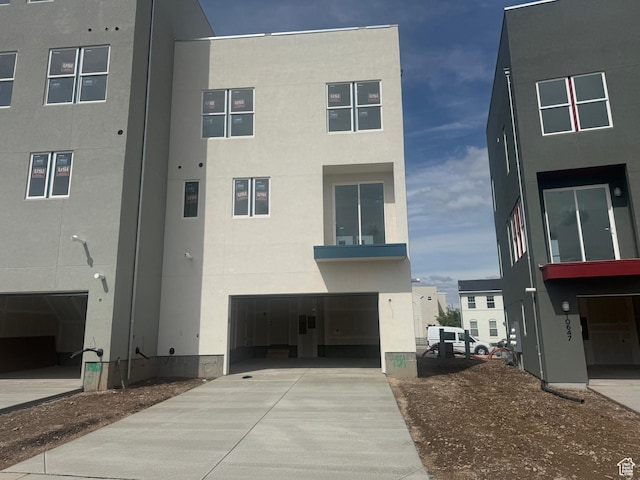 view of building exterior featuring driveway and a garage