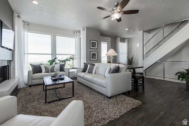 living room with wood finished floors, a textured ceiling, recessed lighting, a ceiling fan, and plenty of natural light