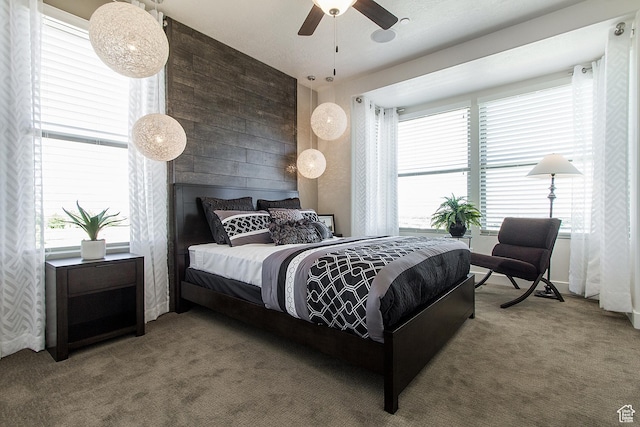 bedroom featuring ceiling fan and carpet
