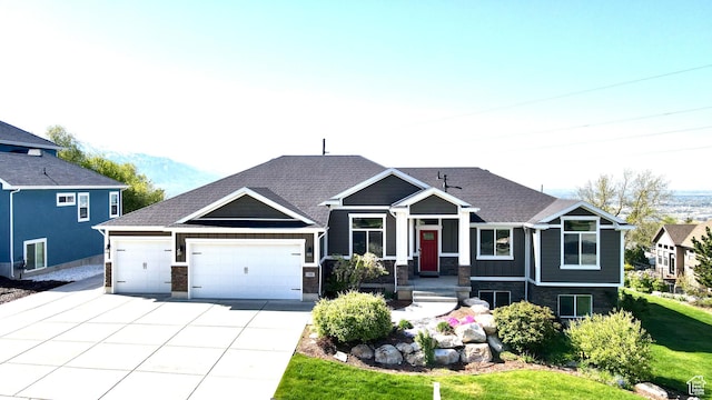view of front facade featuring a garage, a front yard, driveway, and stone siding