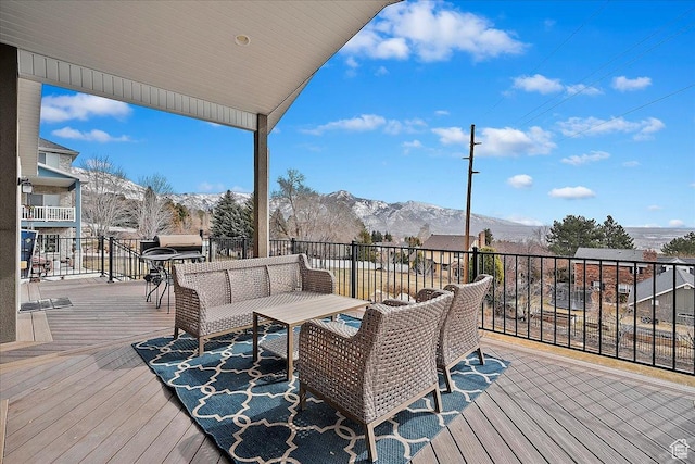 deck featuring outdoor lounge area and a mountain view