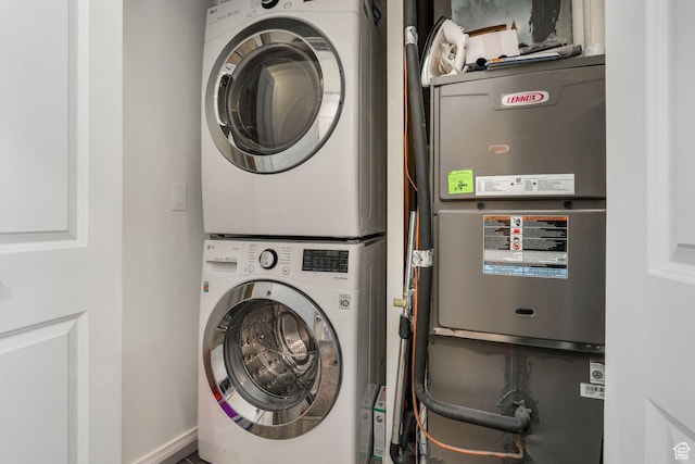 clothes washing area featuring laundry area and stacked washing maching and dryer