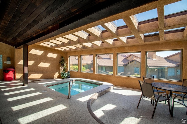 view of pool with an indoor in ground hot tub, outdoor dining area, a patio area, and a pergola