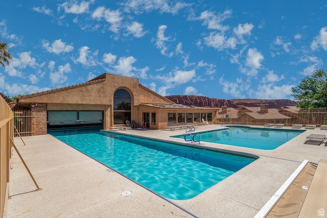 pool featuring a patio and fence