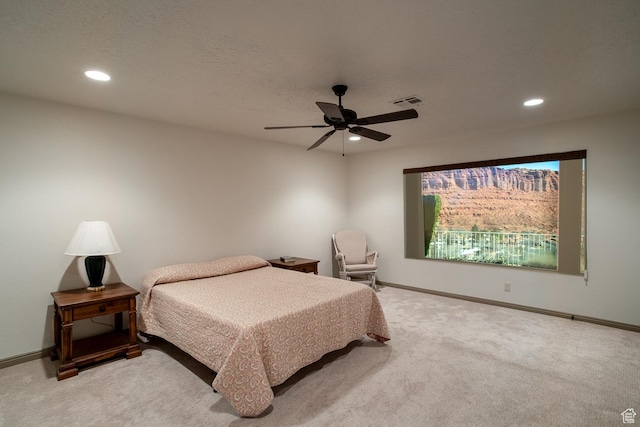 bedroom with recessed lighting, light carpet, and baseboards