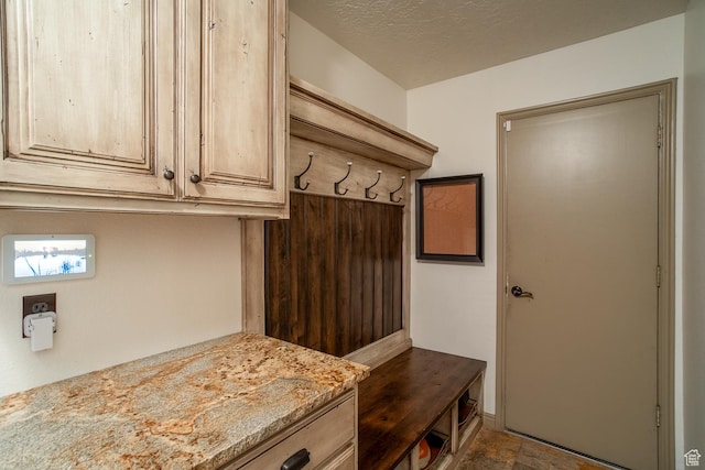 mudroom featuring a textured ceiling