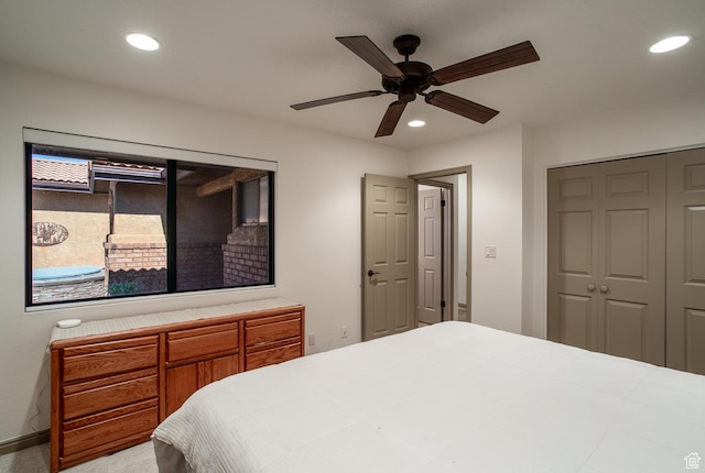 carpeted bedroom featuring recessed lighting, a closet, and ceiling fan