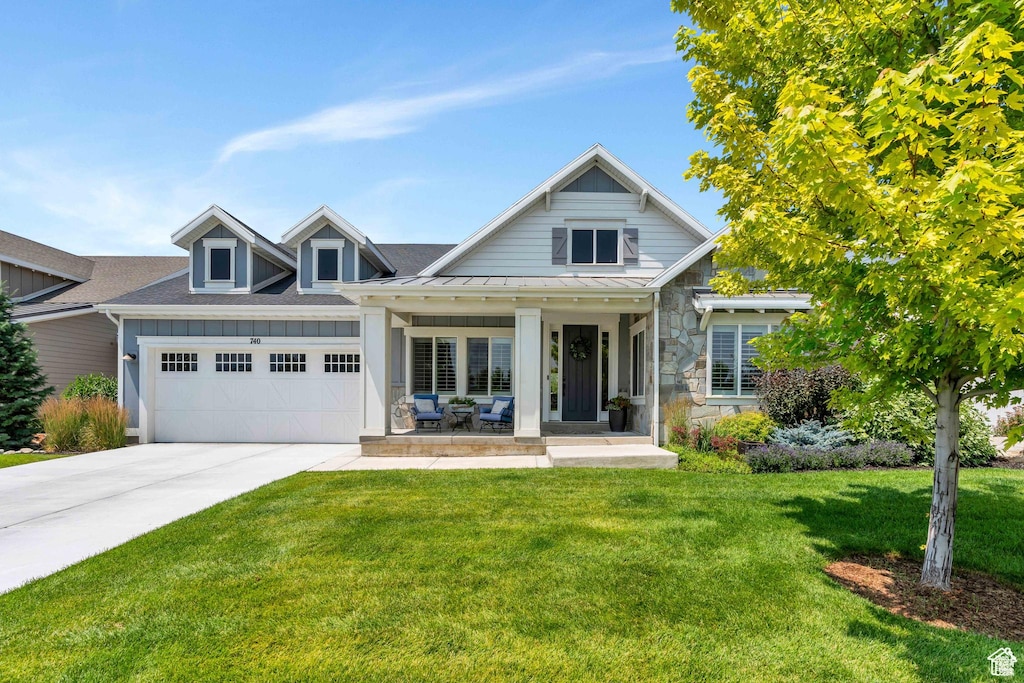 740 S Appenzell Ct, Midway, UT 84049 - view of front facade featuring a garage, concrete driveway, a standing seam roof, covered porch, and a front yard