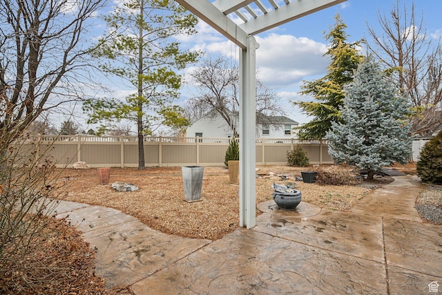 view of yard with a patio, a fenced backyard, and a pergola