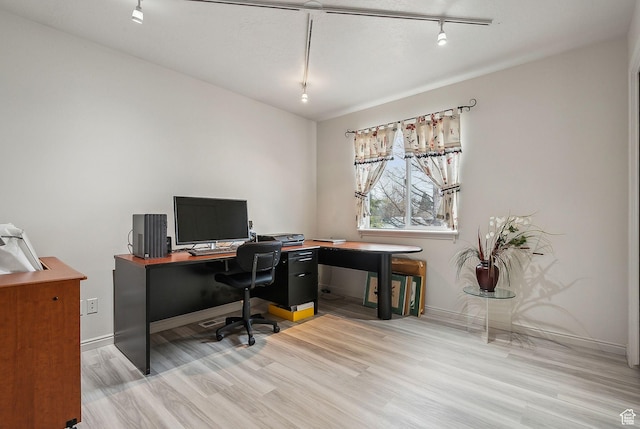 office area featuring rail lighting, baseboards, and wood finished floors