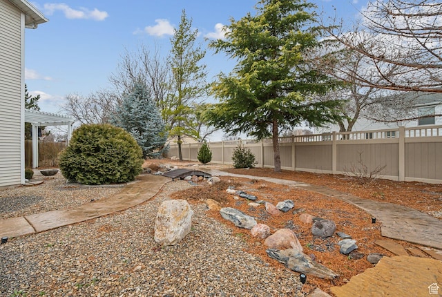 view of yard featuring a fenced backyard and a pergola