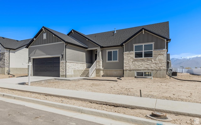 3062 N 2875 W Unit 24, Plain City, UT 84404 - view of front of property featuring stone siding, board and batten siding, a garage, concrete driveway, and roof with shingles