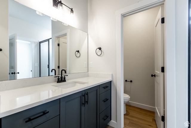 3062 N 2875 W Unit 24, Plain City, UT 84404 - bathroom with toilet, vanity, wood finished floors, baseboards, and an enclosed shower