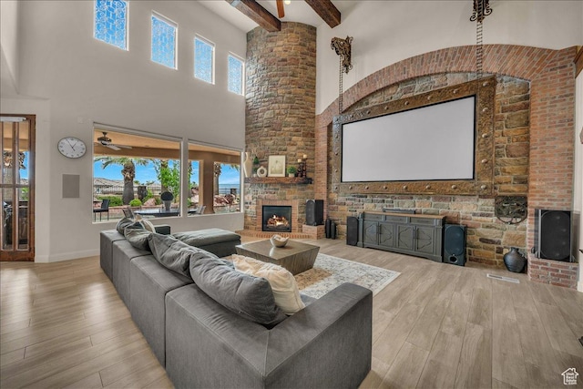 living room with a large fireplace, wood finished floors, and a wealth of natural light