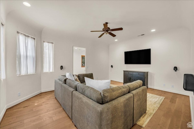 living area with light wood-style flooring, recessed lighting, visible vents, and baseboards