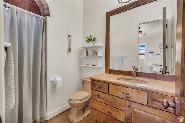bathroom featuring ceiling fan, curtained shower, toilet, vanity, and baseboards