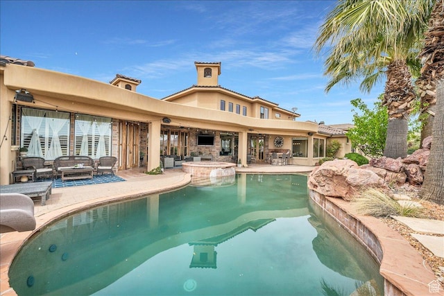 view of swimming pool featuring a pool with connected hot tub and a patio