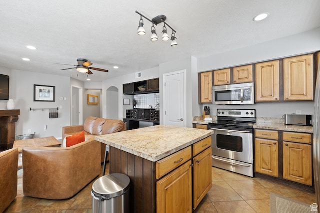 1808 W Fox Bay Dr Unit B304, Heber City, UT 84032 - kitchen with arched walkways, stainless steel appliances, light countertops, and open floor plan