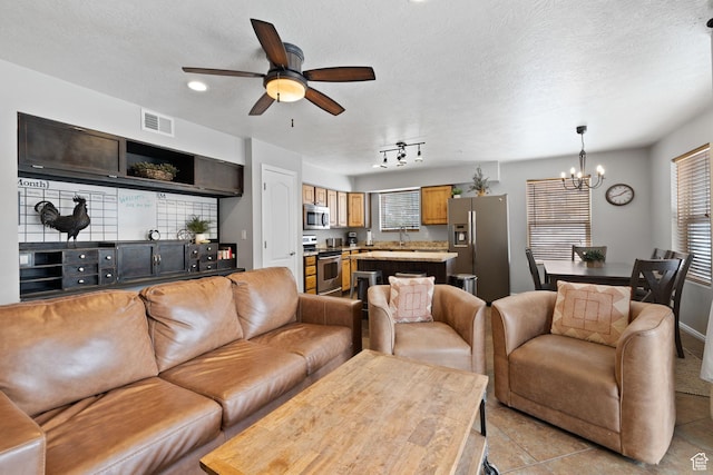 1808 W Fox Bay Dr Unit B304, Heber City, UT 84032 - living room featuring ceiling fan with notable chandelier, visible vents, a textured ceiling, and light tile patterned floors