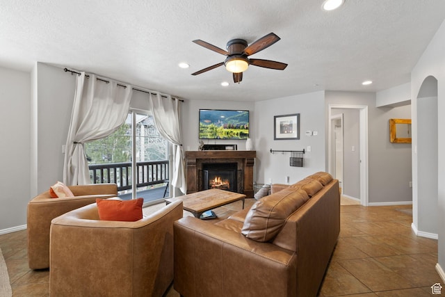 1808 W Fox Bay Dr Unit B304, Heber City, UT 84032 - living room with recessed lighting, ceiling fan, a textured ceiling, a lit fireplace, and baseboards