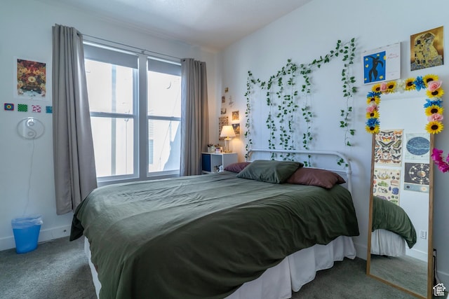 carpeted bedroom featuring baseboards