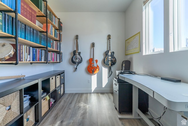 office featuring baseboards and light wood finished floors