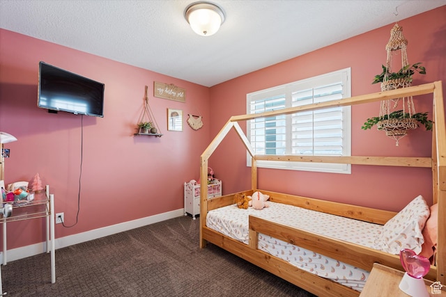 carpeted bedroom featuring a textured ceiling and baseboards